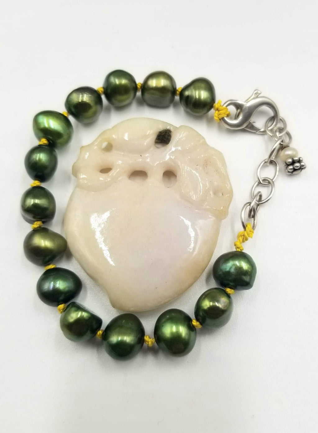 Adjustable sterling silver bracelet, green pearls on golden silk. 5" - 6.75" Length.
