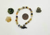 Adjustable sterling silver and multi-stone bracelet on purple silk. 6.75" - 8.25" length.
