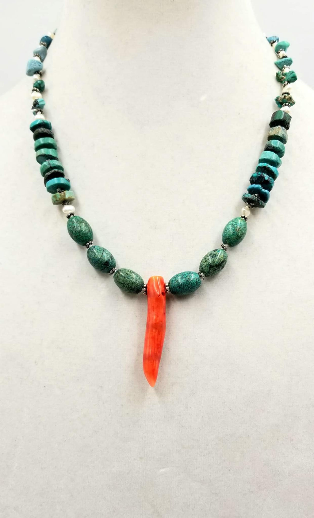 Sterling silver, turquoise, pearl, & coral focal necklace on white silk.