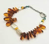 Adjustable, sterling silver, Baltic amber & pearl bracelet on green silk.