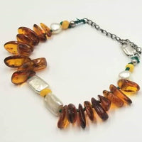 Adjustable, sterling silver, Baltic amber & pearl bracelet on green silk.