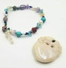 PRICE REDUCED Copper & sterling silver, mult-istone bracelet on green silk. 7" Length.