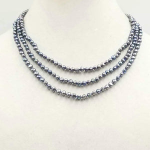Be classy! Three-strand black pearl necklace with 14KYG bookclasp on twilight shades of silk.