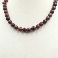 Sterling red jasper & iron tiger's eye necklace on moss green silk.