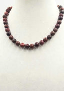 Sterling red jasper & iron tiger's eye necklace on moss green silk.