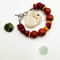 Sterling silver, sponge & red coral bracelet with yellow howlite. 6.25" Length