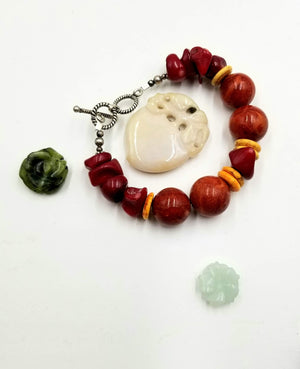 Sterling silver, sponge & red coral bracelet with yellow howlite. 6.25" Length