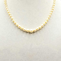 Understated Elegance. 14K yellow gold, graduated cultured pearl necklace on buttercup silk.