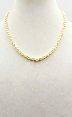 Understated Elegance. 14K yellow gold, graduated cultured pearl necklace on buttercup silk.