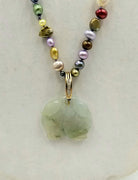 14K Yellow Gold, multi-color pearl necklace with diamond jadeite pendant on lavender silk.