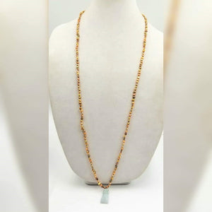Golden pearls on sky blue silk with jadeite hand pendant.  38.5" Length.