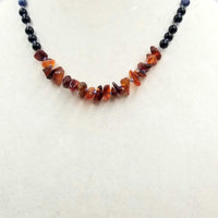 Past Work. Sterling silver, lapis lazuli, onyx, & carnelian necklace on blue silk. 18" Length. Sold