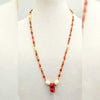 Bi-tone coral,  golden fresh-water cultured pearls, on lavender silk with sterling silver clasp. 28" Length.