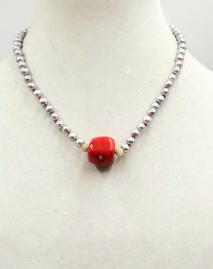 Silvery pearls on crimson silk, with coral and nephrite jade focal & sterling silver clasp. 18.25" Length.