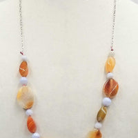 Sterling silver, bi-tone agate necklace on rose silk. 28" Length.