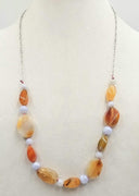 Sterling silver, bi-tone agate necklace on rose silk. 28" Length.