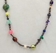 Bronze pearls, agate, coral, malachite, moonstruck, tiger's eye, garnet, jasper,tourmaline, amethyst 10KYG necklace on navy silk. 32" Length.