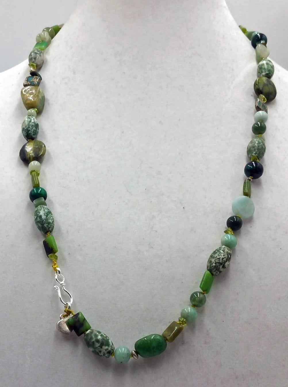 Beautiful long necklace made of sterling silver & various green stones.