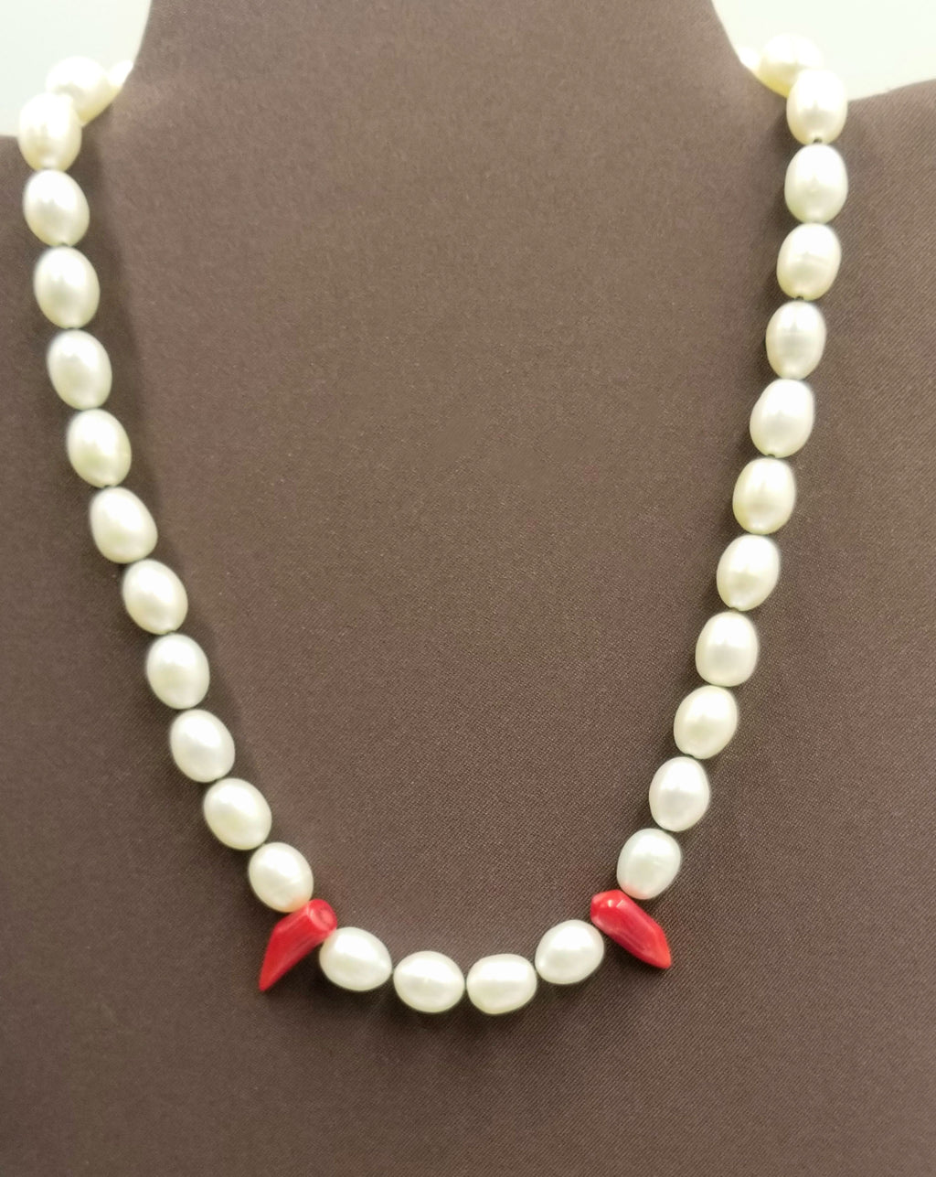 Past Work "Little Fang" a darling goth necklace of Sterling silver, pearl, & red coral on hand-knotted brown silk. 17" Length. Sold