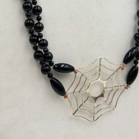"Black Widow" A long, two-strand, onyx & sterling silver spiderweb necklace with smoky quartz accents on hand-knotted coppertone silk. 34" Length.