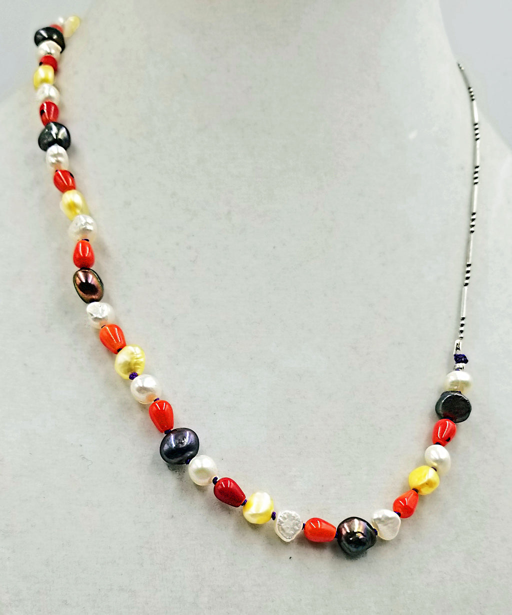 Past Work. Like Halloween Candy?  Coral, multi-colored freshwater cultured pearls, & sterling silver,  unisex necklace with hand-knotted purple silk. 21" Length. Sold.