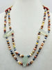 Sterling silver, multi-color freshwater & cultured pearl with coral & prehnite, hand-knotted with purple silk. 27" length.