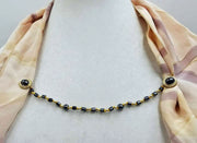 Gold-tone, hematite & gold-filled cape clasp on golden silk.