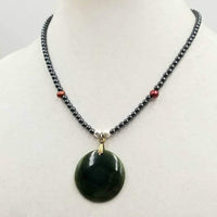 Past Work. Boldly understated, unisex, adjustable, sterling silver, hematite, & pearl necklace with vintage spinach nephrite pendant. 18" - 20" lenth. Sold.