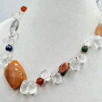 Unique. Unusual. Gorgeous. Wow! You don't have to be a royal to look like one with this necklace of varying stones on silk. 20.5" length.