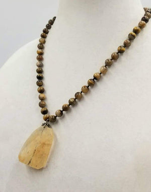 Past Work. Unisex. Sterling silver & tiger's eye necklace with art glass pendant on silk. 20" length. Sold.