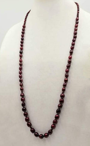 Past Work. A rope necklace 35" long is made of graduated cranberry dyed pearls & rubies on hand-knotted red silk. SOLD.
