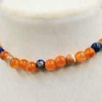 Bold choker necklace with carnelian, dyed shell, lapis lazuli, & agate. Goldfilled clasp. 13.5" length.