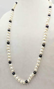 Classic & beautiful, yet modern.  Black & peacock pearl rope necklace hand-knotted with periwinkle silk. 35" length.