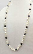 PRICE REDUCED! Classic & beautiful, yet modern.  Black & peacock pearl rope necklace hand-knotted with periwinkle silk. 35" length.