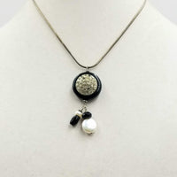Simply beautiful. Sterling silver, onyx, & pearl pendant necklace. 16" length.