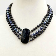 Va Va Voom! Get ready for the red carpet.  14K yellow gold compliments the peacock and black pearls, along with a large faceted onyx focal.