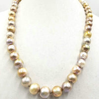 Splendid graduated South Seas Pearl necklace with 14K yellow gold clasp. hand-knotted with dove gray silk.