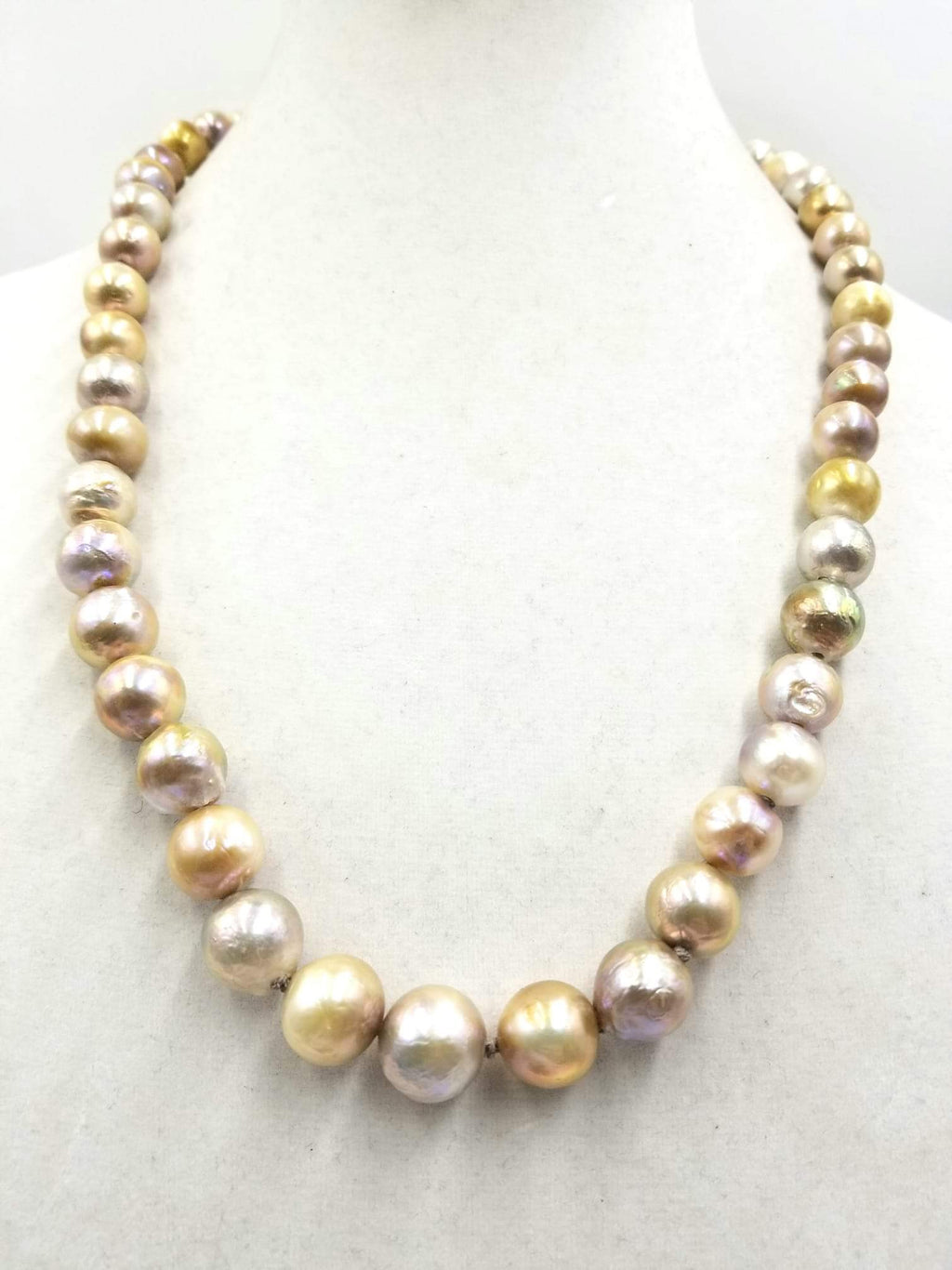 Splendid graduated South Seas Pearl necklace with 14K yellow gold clasp. hand-knotted with dove gray silk.