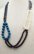 Absolutely beautiful statement piece, modern & classy. Bi-tone pearls, garnet, aquamarine, bold sterling silver chain, loop necklace, hand-knotted with multicolor silk. 28-32" length.