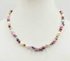 Beautiful multi-colored pearls, 14KYG, necklace on white silk. 20" Matinee length.
