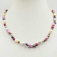 Beautiful multi-colored pearls, 14KYG, necklace on white silk. 20" Matinee length.