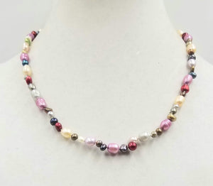 Beautiful multi-colored pearls, 14KYG, necklace on white silk. 20" Matinee length.