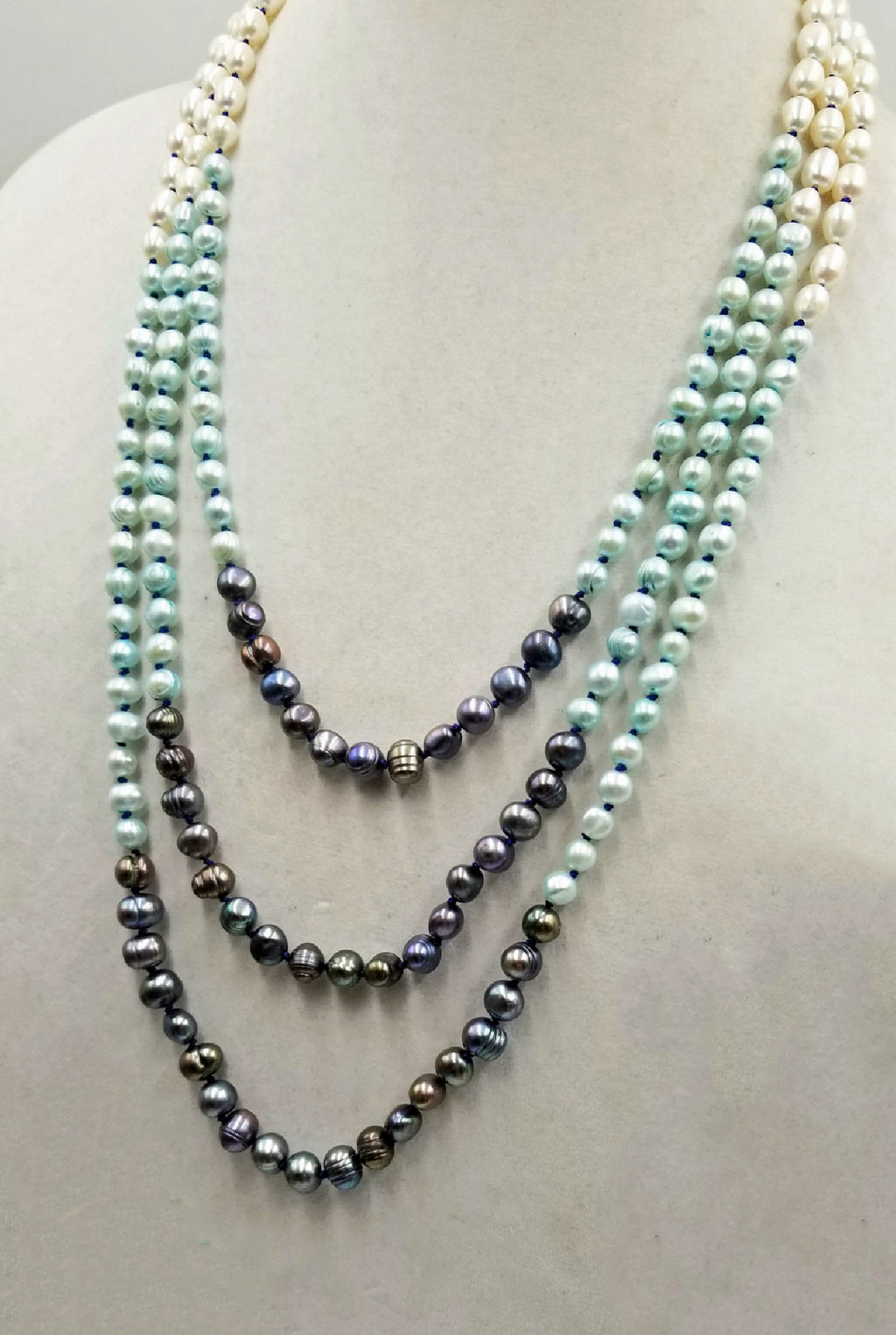 Classic or modern? New to our Aurora Borealis Collection. The black pearls are a knock-out, enhancing the white pearls.  22" shortest strand.