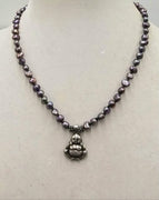 PRICE REDUCED Sterling silver buddha,  freshwater peacock pearl necklace, on hand-knotted forest green silk. 18.5in length.