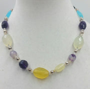 Sterling silver, amethyst, amazonite, onyx, agate, moonstone, hand-knotted white silk. 19.5" Length.