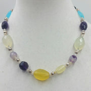 PRICE REDUCED Sterling silver, amethyst, amazonite, onyx, agate, moonstone, hand-knotted white silk. 19.5" Length.