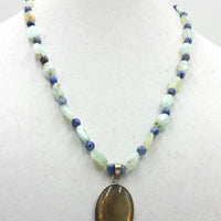 Sterling silver, amazonite, sodalite, labradorite, pendant necklace on beige silk.