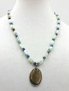 Sterling silver, amazonite, sodalite, labradorite, pendant necklace on beige silk.